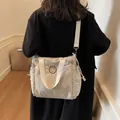 Light gray nylon crossbody bag with fashion bear patch and adjustable woven strap - Off-white
