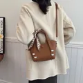 Brown lychee leather bucket bag with houndstooth scarf handle and crossbody strap - Brown