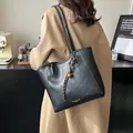 Black PU leather tote bag with unique knot bell pendant and chic wrinkled texture - With Charm / 26*10*24 / Black