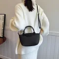 French retro black textured dumpling bag with top handle and adjustable strap for women - Black
