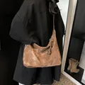 Deep brown oversized crossbody bag with textured faux leather and charm detail - Brown with Pendant