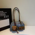 Vintage blue denim Boston bag with brown leather trim and two front utility pockets - No Pendant / Denim Blue
