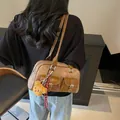 Brown vintage Boston shoulder bag with dual buckle pockets and a cute plush bear charm - Coffee With Charm