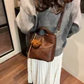 Brown leather minimalist bucket bag with adjustable strap and cute teddy bear charm - With Pendant / Brown