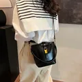 Elegant black bucket bag with golden buckle and glossy finish for women's daily commute - 21*10*18 / Black