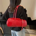 Glossy red cylinder baguette shoulder bag with twin handles and metal buckle decoration - 37*10*13 / Burgundy