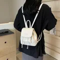 Chic white leather mini backpack with drawstring closure and silver metallic accents - Off White