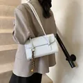 Minimalist light blue underarm bag in glossy faux leather with woven strap detail - With Charm / Blue