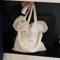 Beige floral mesh tote bag with ruffled chiffon trim and Magic Pocket branding - White