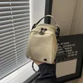 Minimalist beige shell crossbody bag with rope strap and double zipper pockets - Off White