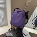 Purple shell-shaped nylon shoulder bag with black and white woven rope strap - Purple