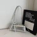 Silver metallic underarm bag featuring lace bow detail and woven handle for women - Silver