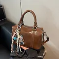 Coffee brown glossy Boston bag with embossed text and cute cartoon bear pendant - With Charm / Coffee