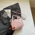 Pink PU leather bowling bag with silk bow and lace details on a grey blazer backdrop - No Pendant / Pink