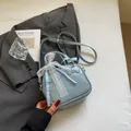 Light blue bowling bag with lace bow and plaid ribbon on a grey blazer background - No Pendant / Blue