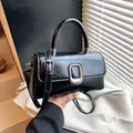 Classic black rectangular handbag with silver metal buckle and versatile shoulder strap - 22x8x13cm / Black