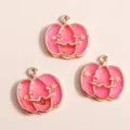 Close-up of pink enamel pumpkin pendants with star and smile details for DIY jewelry - Rose Red
