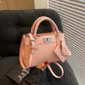 Pink synthetic leather handbag with silver clasp and small matching coin purse - Pink