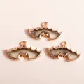 Macro detail of bat-shaped resin pendants with rose gold alloy frame and glitter - Black