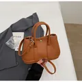 Brown lychee leather bucket bag with top handles and a detachable crossbody strap - Brown No Pendant