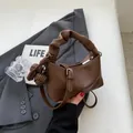 Brown litchi leather dumpling bag with ruched handle and woven ball charm for women - With Pendant / Coffee