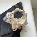 Chic beige ruched dumpling bag with adjustable strap and braided charm accent - With Pendant / Off White
