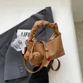 Brown leather dumpling shoulder bag with ruched handle and knotted ball charm detail - With Pendant / Brown