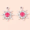 Detailed close-up of alloy sun flower pendants with pink enamel face and small crystals - Silver Red