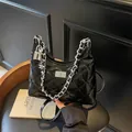Fashionable black quilted shoulder bag with glossy finish and silver chain strap details - Medium / Black