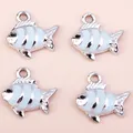 Close-up of enamel koi fish charms with blue and white stripes on a pink surface - 10 Pieces/Pack / Silver Blue
