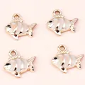 Close-up of four gold and white fish-shaped alloy charms for DIY jewelry making - 10 Pieces/Pack / Gold Light Blue