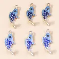 Detail of six blue enamel koi fish charms with gold and silver plated metal borders - Multicolor