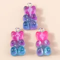 Close-up of three resin gummy bear charms with glitter and colorful gradient finish - Blue-Rose Gradient Bear