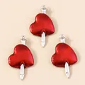 Macro view of three red enamel heart and arrow pendants with silver metal finish - Silver