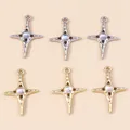Macro shot of 6-piece star cross pendants set in gold and silver finish with moonstone center - Multicolor