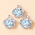 Macro detail of three light blue enamel flower charms with pavé crystals and silver base - Silver Blue