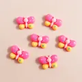 Flat lay of colorful butterfly resin charms for DIY phone case crafts and jewelry making - Rose Red