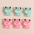 Macro detail of sparkly resin cartoon frogs for DIY phone case crafts and accessories - Multicolor