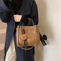 Dark brown large capacity shoulder bag with bear charm and striped ribbon detail - With Pendant / Yellow Brown