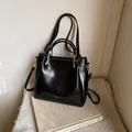 Glossy black tote bag with white contrast stitching and golden hardware details - Basic Style / Black