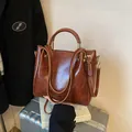 Polished caramel brown faux leather tote bag with dual handles and gold logo detail - Basic Style / Red Brown