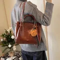 Dark brown faux leather tote bag with plush bear charm and adjustable shoulder strap - With Pendant / Red Brown