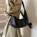 Classic black ruched leather dumpling bag featuring wide shoulder strap for casual wear - Black