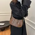 Dunkelbraune Unterachseltasche aus glänzendem Kunstleder mit silbernen Metallschnallen - Braun