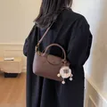 Caramel brown pebbled leather satchel with top handle and cute white plush charm accessory - Small / Coffee (With Pendant)
