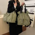 Lightweight olive green drawstring tote bag with large pockets and black handles - Green / Large