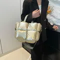 Quilted champagne gold puffer bag with padded handles and adjustable shoulder strap - Gold