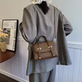Brown small square handbag with vertical ribbed texture and silver metal hardware accents - Brown