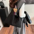 Large black suede tote bag with brown plush bear charm for daily winter commute - Black With Rabbit Pendant
