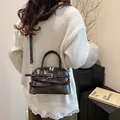 Retro dark brown glossy shell bag with silver buckle strap and shoulder strap - Brown